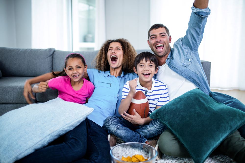 Multi-racial watching football game - Arundel Federal Savings Bank Goal Maker Savings Account